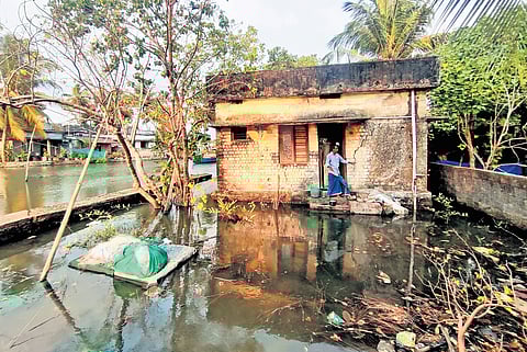 Edakochi resident Raphel in front of his waterlogged house