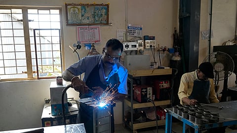 A worker welds a steel chassis at a factory in a suburb of Bengaluru, India, Thursday, Feb. 27, 2025.