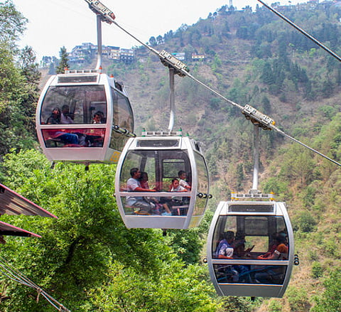 Tourists ride on ropeways at Kempty Falls, in Mussoorie.