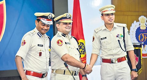 Jagmohan Meena who took charge as new Bhubaneswar DCP with outgoing DCP Pinak Mishra and Police Commissioner S Dev Datta Singh, in Bhubaneswar on Wednesday