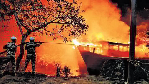 Firefighters trying to douse the blaze at Paradip fishing harbour.