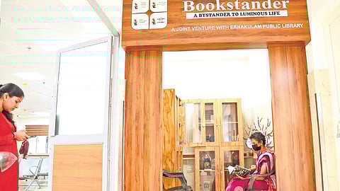 An elderly woman indulged in reading at the Bookstander set up in the oncology ward of the Ernakulam General Hospital