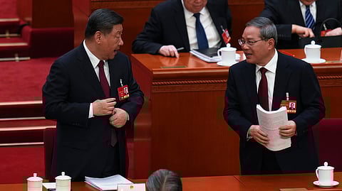 Chinese Premier Li Qiang, right, chats with Chinese President Xi Jinping after the opening session of the National People's Congress (NPC) at the Great Hall of the People in Beijing, China, Wednesday, March 5, 2025.