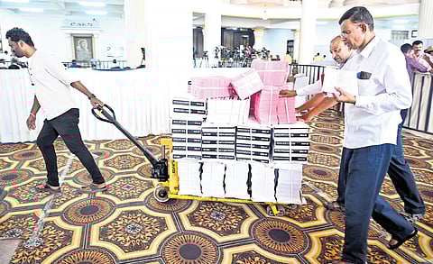 Staff move budget-related material in Vidhana Soudha on Thursday.