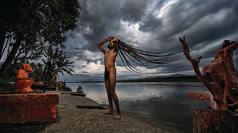 Naga Baba Ganga Giri dries his long jatas (matted hair) near his dhuna on the banks of the Ganges at Haridwar. The long matted hair is symbolic of a sadhu’s
vairagya (detachment). The hair is almost never trimmed as it also represents the kundalini energy flow from the base of the spine to the crown of the head