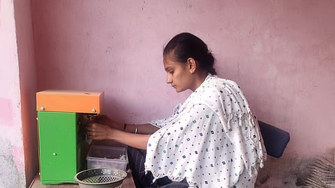 Ramilaben Mukesh Joshi making wicks for lamps.