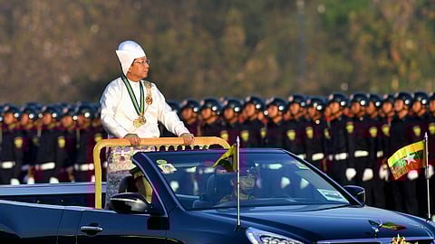 In this photo from January 4, 2023, Myanmar's military chief Min Aung Hlaing stands in a car as he oversees a military display at a parade ground to mark the country's Independence Day in Naypyidaw.