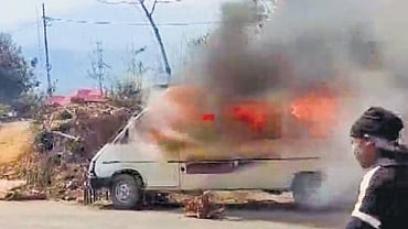 A vehicle in flames after protesters clashed with security personnel in Manipur