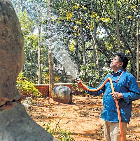 With the onset of summer, a man waters plants at Karnataka Chitrakala Parishath in Bengaluru