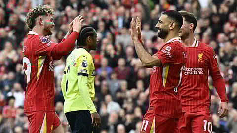 Liverpool's Mohamed Salah celebrates scoring the team's third goal with Harvey Elliott during the EPL football match between Liverpool and Southampton at Anfield in Liverpool, north west England on March 8, 2025.