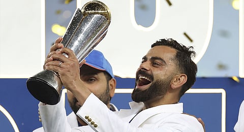 Virat Kohli celebrates with the winners trophy after defeating New Zealand in the final cricket match of the ICC Champions Trophy at Dubai International Cricket Stadium in Dubai, United Arab Emirates, Sunday, March 9, 2025.