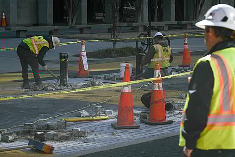 Crews remove light fixtures as they begin work dismantling the "Black Lives Matter" street mural and plaza in Washington, DC, on March 10, 2025.