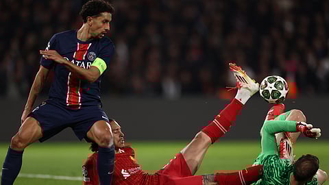 PSG's goalkeeper #01 Gianluigi Donnarumma (R) collides with Liverpool's Uruguayan forward Darwin Nunez (C) in front of PSG's Marquinhos (L) as he attempts to gather the ball during the UEFA Champions League Round of 16 first leg football match between PSG and Liverpool on March 5, 2025.