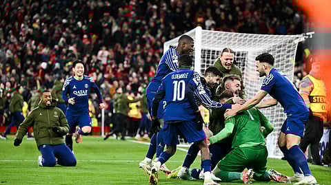 Paris Saint-Germain's players celebrate at the end of the last 16 second leg UEFA Champions League football match between Liverpool and PSG at Anfield in Liverpool, north west England on March 11, 2025.