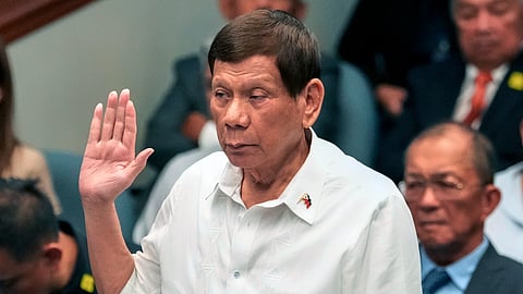 In this photo from Oct. 28, 2024, Former Philippine President Rodrigo Duterte takes oath during a senate inquiry on the so-called war on drugs during his administration at the Philippine Senate in Manila.