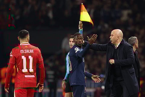 Liverpool's coach Arne Slot (R) gestures from the techincal area during the UEFA Champions League Round of 16 first leg football match between PSG and Liverpool at the Parc des Princes stadium in Paris on March 5, 2025.