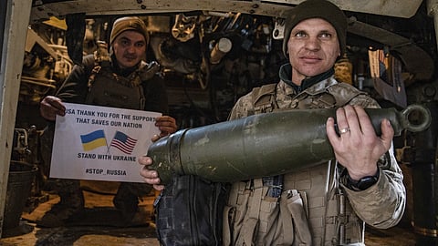 Soldiers of Ukraine's 5th brigade hold a poster thanking for the US for support during a flashmob at the front line near Toretsk, Donetsk region, Ukraine, Tuesday, March 11, 2025.