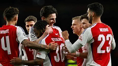 Arsenal's English midfielder #41 Declan Rice (C) celebrates with teammates after scoring his team second goal during the last 16 second leg UEFA Champions League football match between Arsenal and PSV Eindhoven at the Emirates Stadium in north London on March 12, 2025.