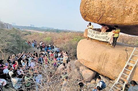 Students and staff of University of Hyderabad protest against the proposed auction of 400 acres of land near the varsity on Thursday.