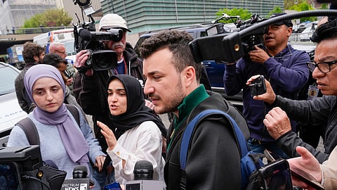 Members of the Columbia University Apartheid Divest group, including Mahmoud Khalil (C), are surrounded by members of the media outside the Columbia University campus, Tuesday, April 30, 2024, in New York.