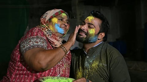 A mother paints the face of her son as they celebrate Hindu festival of Holi in Tharparkar district of the desert town of Mithi, south-eastern Pakistan, on March 13, 2025.