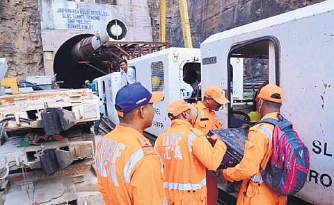 Members of rescue team continue operations at SLBC tunnel collapse site.