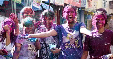 People celebrating Holi festival at Gujili Street in Tiruchy on Friday