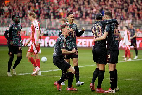 Bayern's Leroy Sane, celebrates with his teammates after scoring his side's opening goal during the Bundesliga football match between Bayern Munich and Union Berlin at the An der Alten Forsterei stadium in Berlin, Germany.