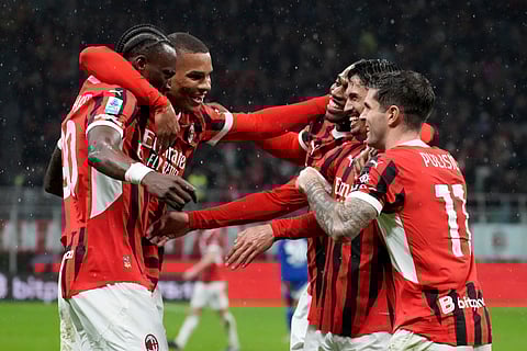 AC Milan's Tijjani Reijnders, second from right, wit teammates celebrates after scoring his side's second goal during the Italian Serie A football match between AC Milan and Como at the San Siro Stadium in Milan, Italy.