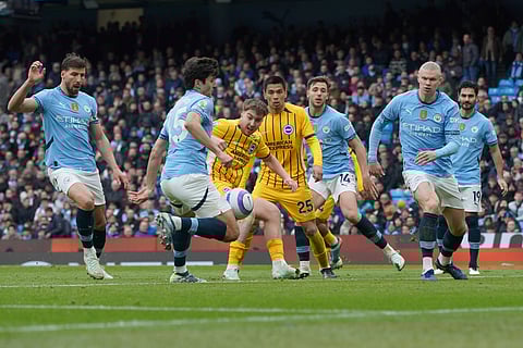 Manchester City's Abdukodir Khusanov, second left, scores an own goal during the English Premier League football match between Manchester City and Brighton and Hove Albion at Etihad stadium in Manchester, England.