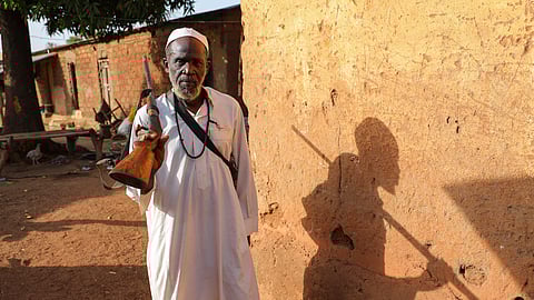 Amidou Diarasumba, leader of the Dozo clan (Dozo-ba) poses for a photograph in his home in Kimbirila-Nord, Ivory Coast, Feb. 21, 2025.