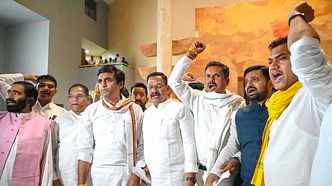 Congress MLAs shout slogans after a walkout during the Budget session of the Madhya Pradesh Assembly, in Bhopal.