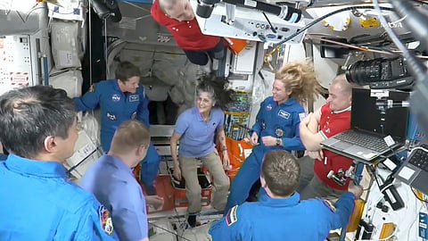 This image made from video by NASA shows astronauts, including Suni Williams, center, greeting each other after a SpaceX capsule docked with the International Space Station.