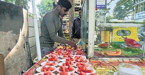 A vendor sells watermelons in Bengaluru on Monday. Temperature has been on
a rise across Karnataka.