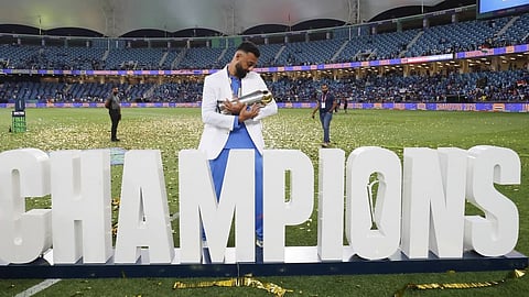 Varun Chakravarthy celebrates after winning the Champions Trophy in Dubai