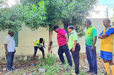 Environmental activists uprooting conocarpus trees grown at Tharuvai ground in Thoothukudi.