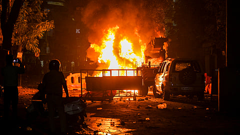 A fire set by miscreants amid violence following an agitation by a right-wing group demanding removal of Aurangzeb's tomb, in Nagpur on Monday night, March 17, 2025.