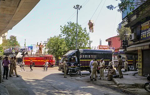 Police personnel keep a vigil at Chitnis Park area amid curfew after violence erupted on Monday night, in Nagpur, Tuesday, March 18, 2025.