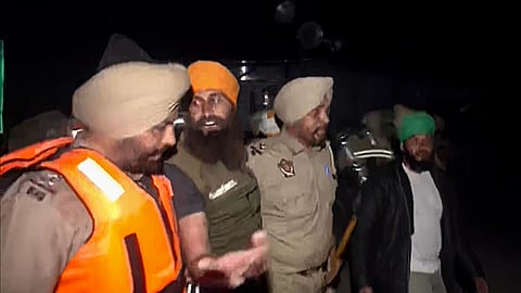 Police remove farmers at Punjab-Haryana Shambhu Border where they were sitting on a protest over various demands, on Wednesday.