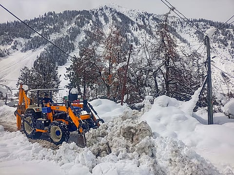 A snow clearing machine being used to remove snow from a road at Sissu, in Lahaul and Spiti district.