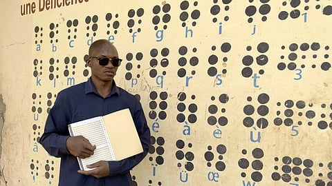 Amadou Ndiaye holds a Braille tablet in Bamako, Mali, Sunday, Jan. 26, 2025.
