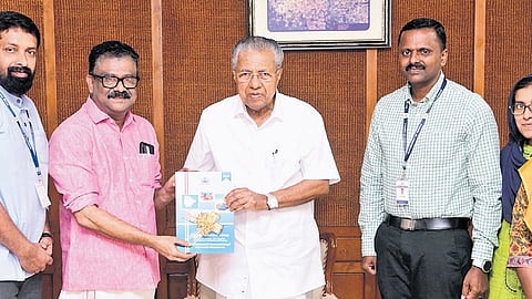 Chief Minister Pinarayi Vijayan releasing the report of the gender survey held in Kattakada assemblu constituency by handing over a copy to MLA I B Satheesh.
