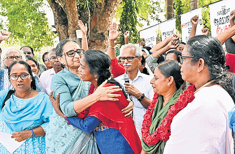 Former KSDMA member and activist K G Thara hugs ASHA workers who are on a hunger strike after inaugurating their protest in front of the Secretariat on Thursday.