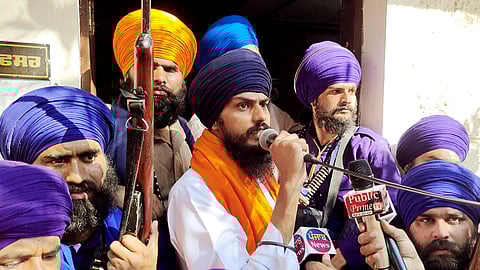 In this photo from Feb. 23, 2023, pro-Khalistan separatist preacher and 'Waris Punjab De' chief Amritpal Singh (C) speaks to the media near Amritsar.