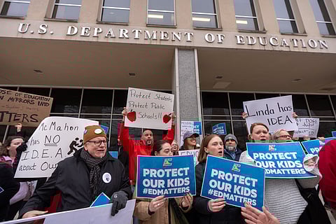 Protestors gather during a demonstration at the headquarters of the Department of Education, Friday, March 14, 2025, in Washington.