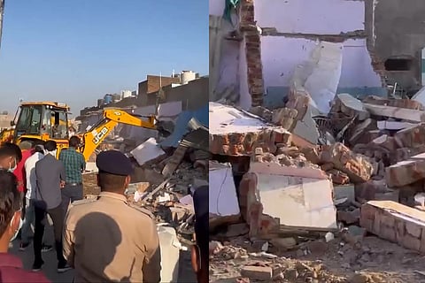 Ahmedabad Police personnel oversee the demolition of unauthorized constructions associated with known offenders, as part of a statewide crackdown on illegal properties linked to criminal elements.