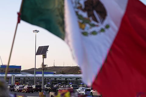 Vehicles wait in line to cross the border into the United States at the San Ysidro Port of Entry, Tuesday, March 18, 2025, in Tijuana, Mexico.