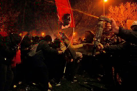 Anti riot police officers use tear gas during clashes with people in Istanbul, Turkey, Thursday, March 20, 2025, as they protest against the arrest of Istanbul's Mayor Ekrem Imamoglu.