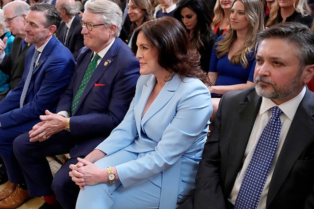 Tiffany Justice, co-founder of Moms for Liberty, second from right, listens as President Donald Trump speaks at an education event and executive order signing in the East Room of the White House in Washington, Thursday, March 20, 2025.