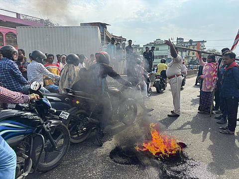 Tribal people block the Ranchi-Jamshedpur road during Ranchi bandh in protest against the construction of a flyover near a Sarna Sthal, a sacred tribal religious site, in Ranchi, Jharkhand, Saturday, March 22, 2025.